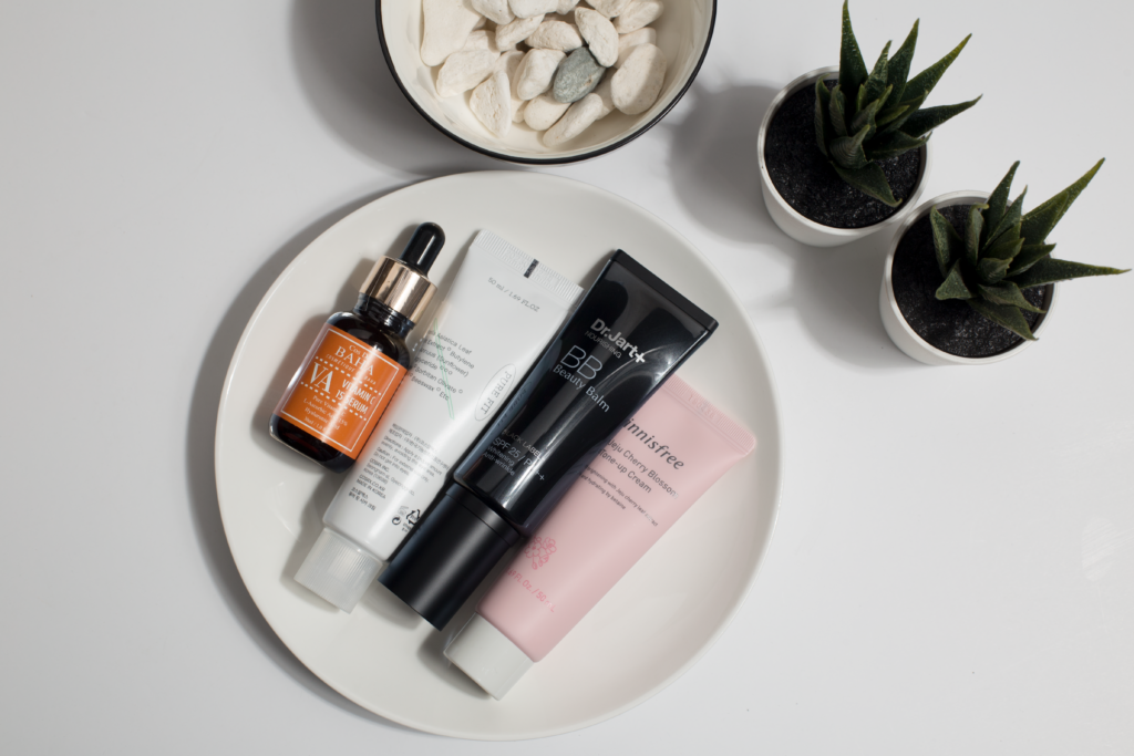 The 5-Step Korean Skincare Routine for Beginners Elevate your skincare routine with this minimalist product display featuring various cosmetics on a white plate.