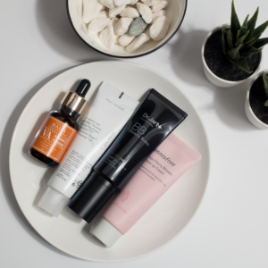 Homepage New Elevate your skincare routine with this minimalist product display featuring various cosmetics on a white plate.